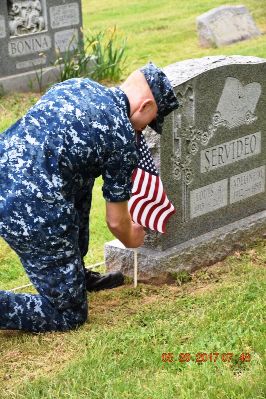 placing flags on veteran graves